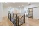 Hallway with wood floors, wood and metal railing, neutral paint and glass sliding door at 3840 Wieuca Ne Ter, Atlanta, GA 30342