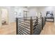 Hallway with wood floors and a railing with an opening to a bathroom and other rooms at 3840 Wieuca Ne Ter, Atlanta, GA 30342
