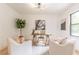 Bright home office featuring white walls, a modern desk, a stylish light fixture, and modern art at 3840 Wieuca Ne Ter, Atlanta, GA 30342