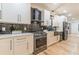 Modern kitchen featuring stainless steel appliances, white cabinets, black subway tile backsplash, and a gas range at 3840 Wieuca Ne Ter, Atlanta, GA 30342