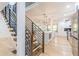 Open concept kitchen with stainless steel appliances, island, and modern staircase at 3840 Wieuca Ne Ter, Atlanta, GA 30342