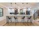 Elegant kitchen featuring a large island with bar seating, modern lighting, and stainless steel appliances at 3840 Wieuca Ne Ter, Atlanta, GA 30342