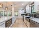 Spacious kitchen with white cabinets, stainless steel appliances, black accents, and a large island at 3840 Wieuca Ne Ter, Atlanta, GA 30342