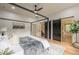Bright main bedroom featuring barn door access to the closet and a four-post canopy bed at 3840 Wieuca Ne Ter, Atlanta, GA 30342