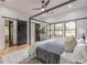 Main bedroom featuring a four-poster bed, sliding barn doors, and large windows for lots of natural light at 3840 Wieuca Ne Ter, Atlanta, GA 30342