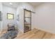 Bright sitting room area with wood floors, natural light and a stylish glass barn door at 3840 Wieuca Ne Ter, Atlanta, GA 30342