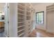 Bright walk-in closet with custom shelving, drawers, and wood flooring for organized storage at 3840 Wieuca Ne Ter, Atlanta, GA 30342