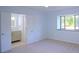 Bright bedroom with adjacent bathroom, carpet flooring and large window overlooking lush landscaping at 4270 Mountain Glen Trce, Snellville, GA 30039