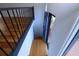 Foyer with blue door, wood floors and wrought iron railing and staircase leading to the second floor at 4270 Mountain Glen Trce, Snellville, GA 30039
