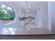 Bright kitchen featuring white cabinets, modern appliances, granite counters and a unique window detail at 4270 Mountain Glen Trce, Snellville, GA 30039