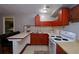 Cozy kitchen with wood cabinets, tile counters, and a vintage white stove at 4270 Mountain Glen Trce, Snellville, GA 30039