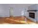 Spacious living room featuring hardwood floors, a stone fireplace, and natural light at 4270 Mountain Glen Trce, Snellville, GA 30039