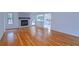 Bright living room showcasing hardwood floors, a stone fireplace, and seamless transition to the kitchen at 4270 Mountain Glen Trce, Snellville, GA 30039