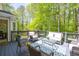 Relaxing back deck with comfortable seating, perfect for outdoor entertaining and enjoying the wooded view at 6005 Cherecobb Ln, Woodstock, GA 30188