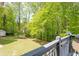 View of lush backyard featuring a well-maintained lawn, mature trees, and storage shed at 6005 Cherecobb Ln, Woodstock, GA 30188