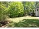 Expansive backyard offers lush greenery and peaceful wooded views at 6005 Cherecobb Ln, Woodstock, GA 30188