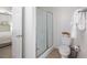 Bathroom with shower, toilet, and a view to the light and airy bedroom at 6005 Cherecobb Ln, Woodstock, GA 30188