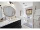 Stylish bathroom featuring modern fixtures, vanity with countertop space, and white tiled floors at 6005 Cherecobb Ln, Woodstock, GA 30188