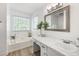 Bright bathroom featuring a tub, vanity with countertop space and stylish fixtures at 6005 Cherecobb Ln, Woodstock, GA 30188