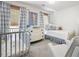 Charming bedroom featuring modern decor, crib, daybed, and large windows at 6005 Cherecobb Ln, Woodstock, GA 30188