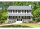Inviting two-story home featuring a welcoming front porch and lush green lawn at 6005 Cherecobb Ln, Woodstock, GA 30188