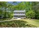 Charming two-story home with a classic facade, inviting curb appeal, and meticulously kept lawn at 6005 Cherecobb Ln, Woodstock, GA 30188