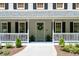 Charming front porch with seating area, plants, and traditional architectural details at 6005 Cherecobb Ln, Woodstock, GA 30188