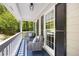Relaxing porch with comfortable seating and a view of the wooded surroundings at 6005 Cherecobb Ln, Woodstock, GA 30188