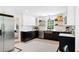 Well-designed kitchen with contrasting cabinets, stainless steel appliances, and a copper sink at 6005 Cherecobb Ln, Woodstock, GA 30188