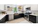 Beautiful kitchen with subway tile backsplash, stainless steel appliances, and black and white flooring at 6005 Cherecobb Ln, Woodstock, GA 30188