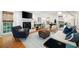 Bright living room features hardwood floors, fireplace with TV, and comfortable seating at 6005 Cherecobb Ln, Woodstock, GA 30188