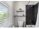 Small bathroom features a tiled shower, toilet, and modern fixtures with natural light at 631 Boulevard Ne, Atlanta, GA 30308