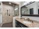 Bathroom featuring a tiled shower with glass door, granite counters, and dark wood cabinets at 631 Boulevard Ne, Atlanta, GA 30308