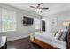 Bedroom showcasing a ceiling fan, mounted tv, hardwood floors, and natural light at 631 Boulevard Ne, Atlanta, GA 30308