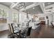 Open dining area with a glass table, modern chairs, and seamless flow to the kitchen and living spaces at 631 Boulevard Ne, Atlanta, GA 30308