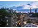 Beautiful brick home with a rooftop deck overlooking the city skyline at twilight at 631 Boulevard Ne, Atlanta, GA 30308