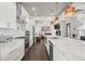 Bright kitchen features white cabinets, marble countertops, stainless steel appliances, and copper pendant lights at 631 Boulevard Ne, Atlanta, GA 30308