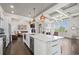 Well-lit kitchen with white cabinets, marble countertops, stainless steel appliances, and a large island at 631 Boulevard Ne, Atlanta, GA 30308