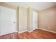 Simple bedroom featuring two closets, neutral walls, and wood-look flooring at 24 Autry Road, Auburn, GA 30011