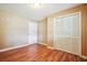 Bedroom with wood floors, white door, and a closet with paneled doors at 24 Autry Road, Auburn, GA 30011