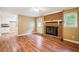 Living room showcasing a fireplace, ceiling fan, and view into adjacent kitchen area at 24 Autry Road, Auburn, GA 30011