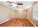 Inviting living room with beautiful laminate floors, ceiling fan, and large windows at 24 Autry Road, Auburn, GA 30011