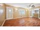 Bright living room with hardwood floors, ceiling fan, and an exit door for convenience at 24 Autry Road, Auburn, GA 30011