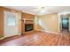 Cozy living room with a brick fireplace, ceiling fan, and access to a hallway at 24 Autry Road, Auburn, GA 30011