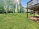 Expansive backyard with lush green lawn and mature trees, perfect for outdoor activities and relaxation at 319 Primrose Ln, Auburn, GA 30011