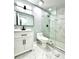 Updated bathroom features a modern vanity, toilet and glass shower stall with marble tile at 319 Primrose Ln, Auburn, GA 30011