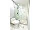 Modern bathroom featuring white marble tile and a glass-enclosed shower stall at 319 Primrose Ln, Auburn, GA 30011