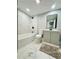 Bathroom featuring a tub, shower, vanity, and marble tile floor at 319 Primrose Ln, Auburn, GA 30011