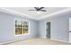 Spacious bedroom with large window and tray ceiling, ready for personal touches at 319 Primrose Ln, Auburn, GA 30011