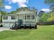 Beautifully renovated home featuring a manicured lawn, covered porch, and a convenient two-car garage at 319 Primrose Ln, Auburn, GA 30011